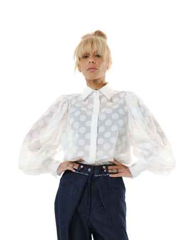 White sheer polka dot puff sleeve shirt with a pointed collar and voluminous sleeves, perfect for a sophisticated look.