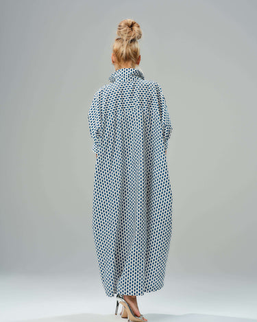 Back view of an oversized shirt dress in blue micro floral print, showcasing a relaxed silhouette and classic collar.