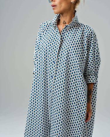 Oversized shirt dress with blue micro floral print, featuring a relaxed silhouette and button-down closure.