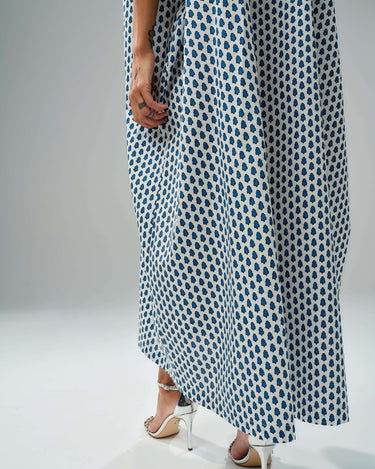 Model wearing an oversized shirt dress with a blue micro floral print, showcasing relaxed silhouette and chic style.