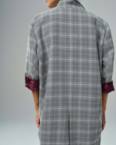 Back view of a light grey checked oversized blazer with burgundy paisley lining on sleeves.
