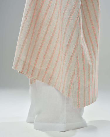 Close-up of a striped linen-cotton kimono showcasing delicate stripes in light fabric, styled over white wide-leg pants.
