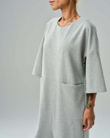 Grey wide-leg jumpsuit featuring cropped sleeves and relaxed fit, perfect for casual comfort and modern style.