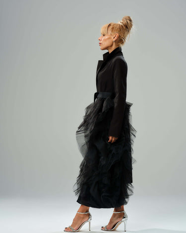 Black Tulle Detail Blazer with satin belt, featuring dramatic tulle accent, modeled with high collar and elegant silhouette.