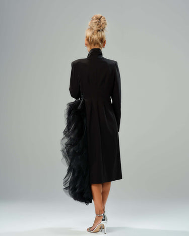 Back view of a black tulle detail blazer with dramatic layered fabric and a high collar design.