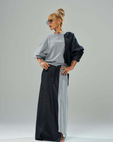 Model showcasing a grey and denim co-ord set with a loose sweatshirt and flowing maxi skirt, featuring unique textures.
