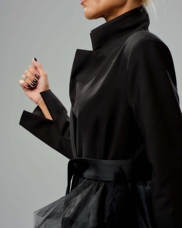 Black tulle detail blazer with satin belt and high collar, showcasing dramatic volume and tailored fit.