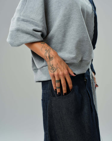 Casual grey and denim co-ord set featuring a relaxed sweatshirt and flowing maxi skirt with unique textures.