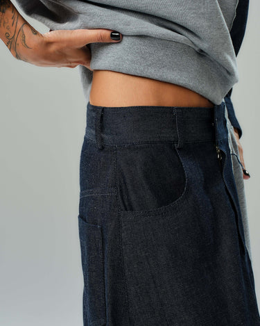 Side view of grey sweatshirt and dark denim skirt co-ord set showcasing modern, relaxed design and contrasting textures.