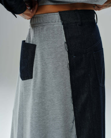 Side view of grey and denim co-ord set, featuring a pocket on grey fleece and dark denim panel, showcasing modern design.