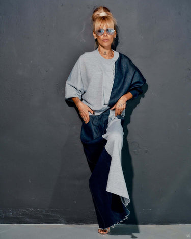Model wearing a contemporary grey and denim co-ord set, featuring a relaxed sweatshirt and flowing maxi skirt.