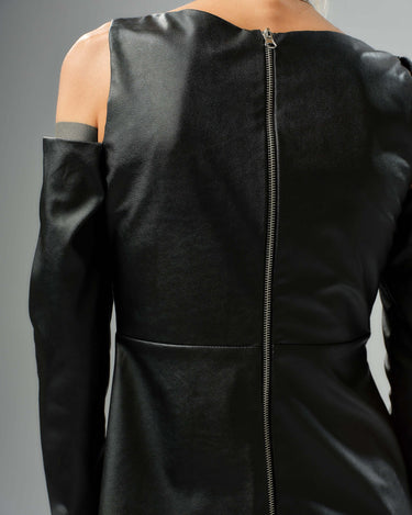 Back view of a black faux leather top with cut-out shoulder details and a zipper closure, highlighting its modern design.