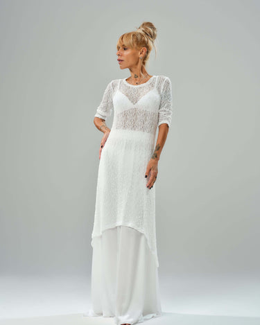Model showcasing a white maxi co-ord set with tunic and elastic waist skirt, featuring a sheer texture and flowy design.