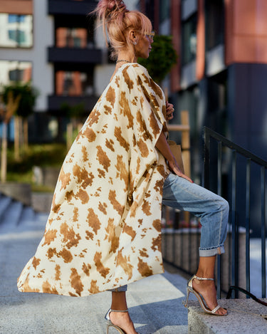 Beige Printed Asymmetric Tunic worn over jeans with a stylish silhouette and camel-toned abstract print.