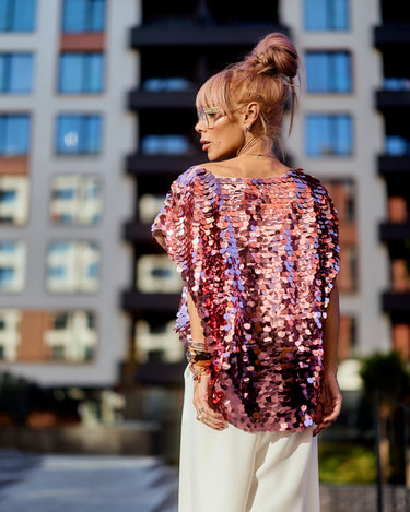 Model wearing a Pink Sequin Oversized Top with pink sequins shimmering against an urban backdrop.