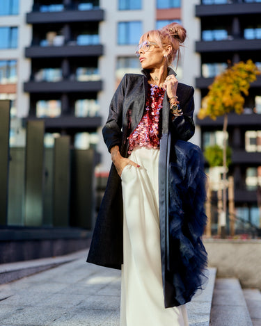 Model wearing a Denim Tulle Detail Blazer with tulle ruffle, styled for urban chic look.