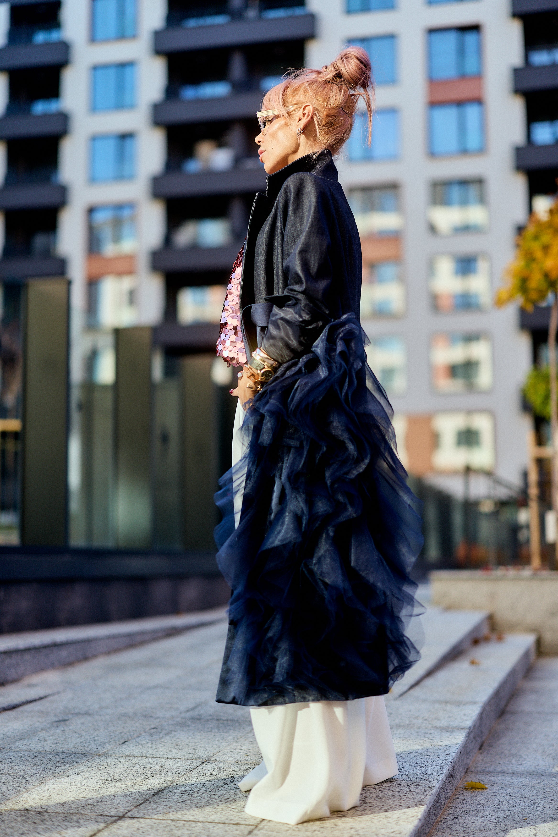 Side view of a model wearing a Denim Tulle Detail Blazer with tulle ruffle cascading down, styled for urban fashion.