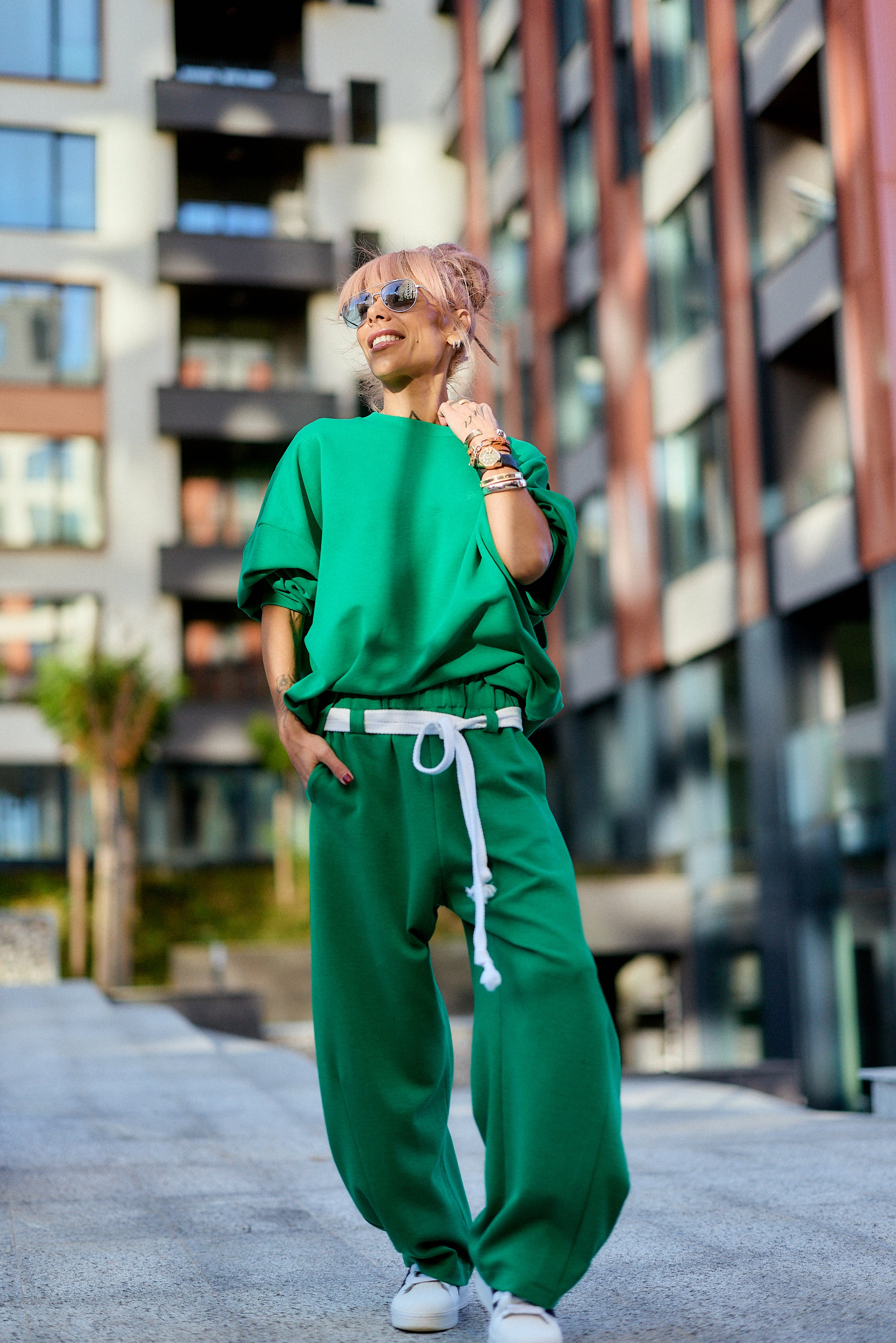 Green Oversized Sweat Set with Open Back worn by a stylish model outdoors, showcasing modern streetwear vibes.
