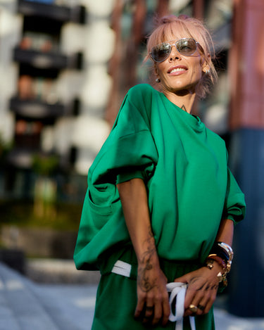 Green Oversized Sweat Set with Open Back featuring a relaxed fit and open-back detail against a stylish urban backdrop.