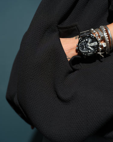 Black Oversized Textured Jacket with roomy pocket and stylish watch detail, showcasing modern streetwear.