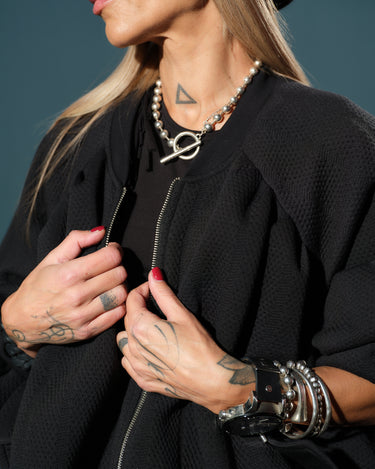 Black Oversized Textured Jacket worn with stylish accessories, showcasing its relaxed fit and modern streetwear appeal.