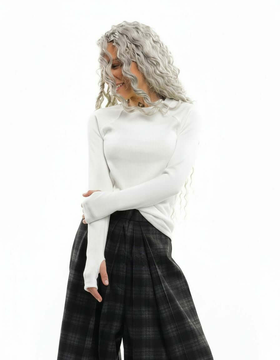 Model wearing a White Rib-Knit Top with thumbhole sleeves paired with plaid pants.