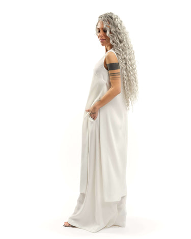Sleeveless Maxi Tunic Suspended from barely-there straps that crisscross and tie at the back, this dress drapes fluidly, catching movement with every step. The midi length strikes the perfect balance between elegance and ease. FEATURES:Black midi dress wi