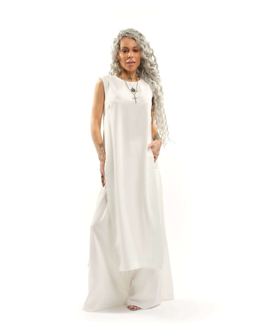 Sleeveless Maxi Tunic Suspended from barely-there straps that crisscross and tie at the back, this dress drapes fluidly, catching movement with every step. The midi length strikes the perfect balance between elegance and ease. FEATURES:Black midi dress wi