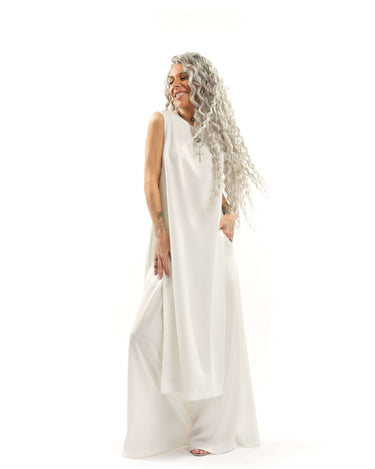 Sleeveless Maxi Tunic Suspended from barely-there straps that crisscross and tie at the back, this dress drapes fluidly, catching movement with every step. The midi length strikes the perfect balance between elegance and ease. FEATURES:Black midi dress wi