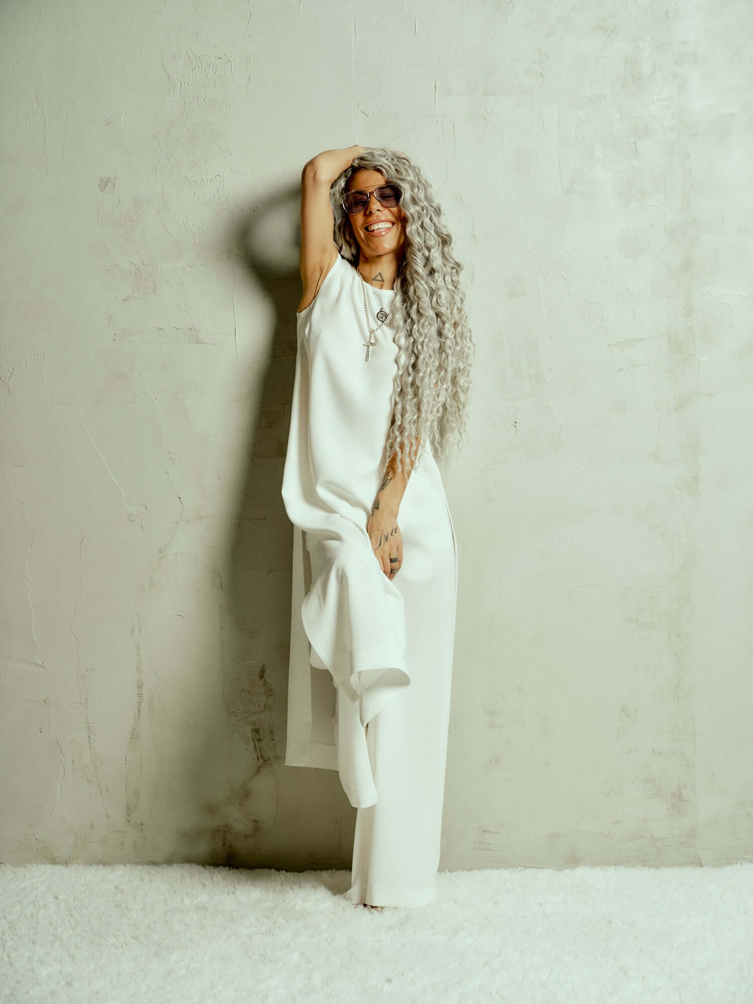 Sleeveless Maxi Tunic Suspended from barely-there straps that crisscross and tie at the back, this dress drapes fluidly, catching movement with every step. The midi length strikes the perfect balance between elegance and ease. FEATURES:Black midi dress wi