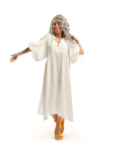 Cotton-Blend Midi Dress Designed with a relaxed, babydoll silhouette, this dress drapes effortlessly, letting the fabric move with ease. The billowing sleeves fall just above the wrists, adding a touch of structure to the fluid shape, while the v-neckline