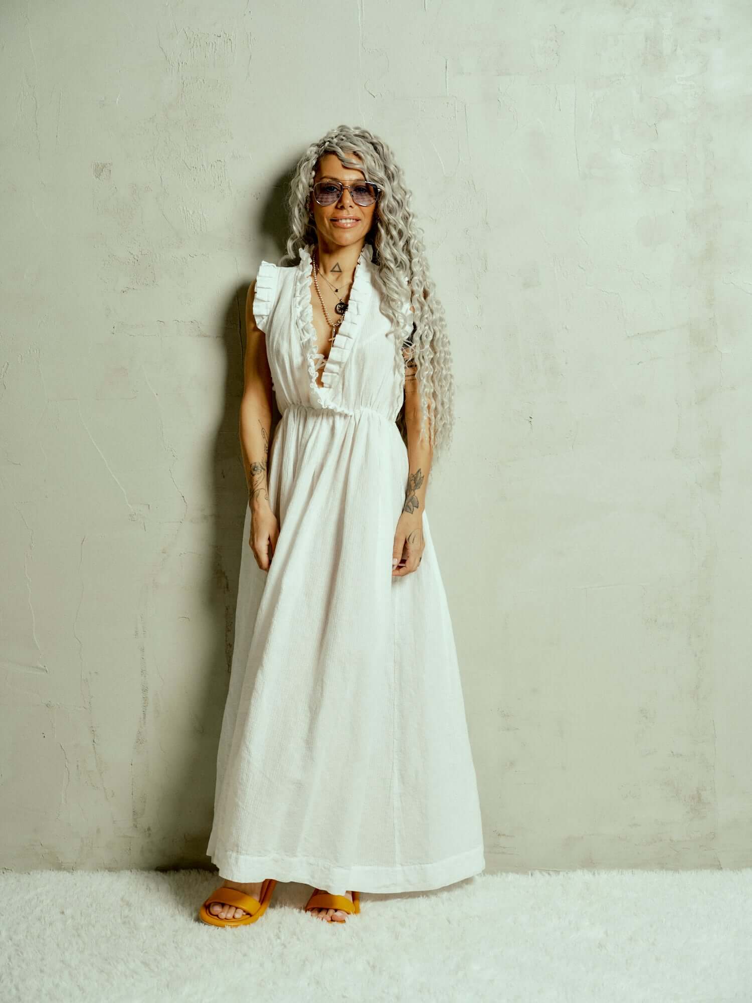 Ruffled Cotton-Blend Maxi Dress There’s something about ruffles that feels like pure romance. Cut from airy fabric, this dress moves with you, making every step feel like part of a story, one filled with golden afternoons, candlelit dinners, and the kind