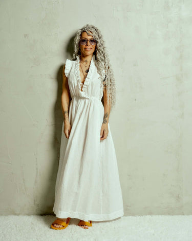Ruffled Cotton-Blend Maxi Dress There’s something about ruffles that feels like pure romance. Cut from airy fabric, this dress moves with you, making every step feel like part of a story, one filled with golden afternoons, candlelit dinners, and the kind