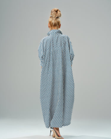 Back view of an oversized shirt dress in blue micro floral print, showcasing a relaxed silhouette and classic collar.