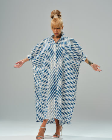 Model showcasing an oversized shirt dress with a blue micro floral print, featuring a relaxed silhouette and classic collar.