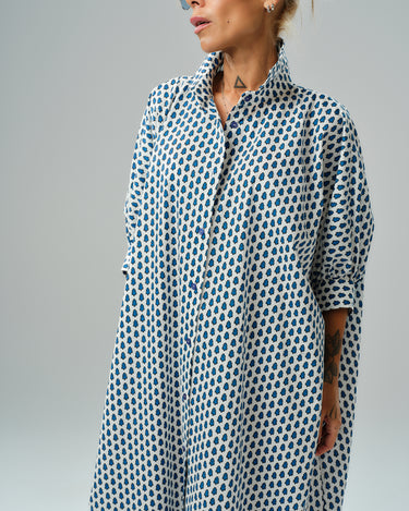Oversized shirt dress with blue micro floral print, featuring a relaxed silhouette and button-down closure.
