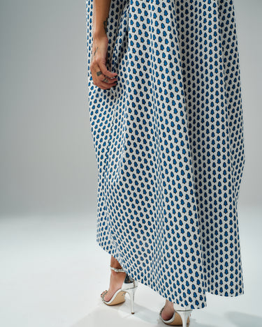 Model wearing an oversized shirt dress with a blue micro floral print, showcasing relaxed silhouette and chic style.
