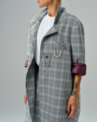 Light grey checked oversized blazer with chain detail and burgundy paisley lining, styled with culotte trousers.