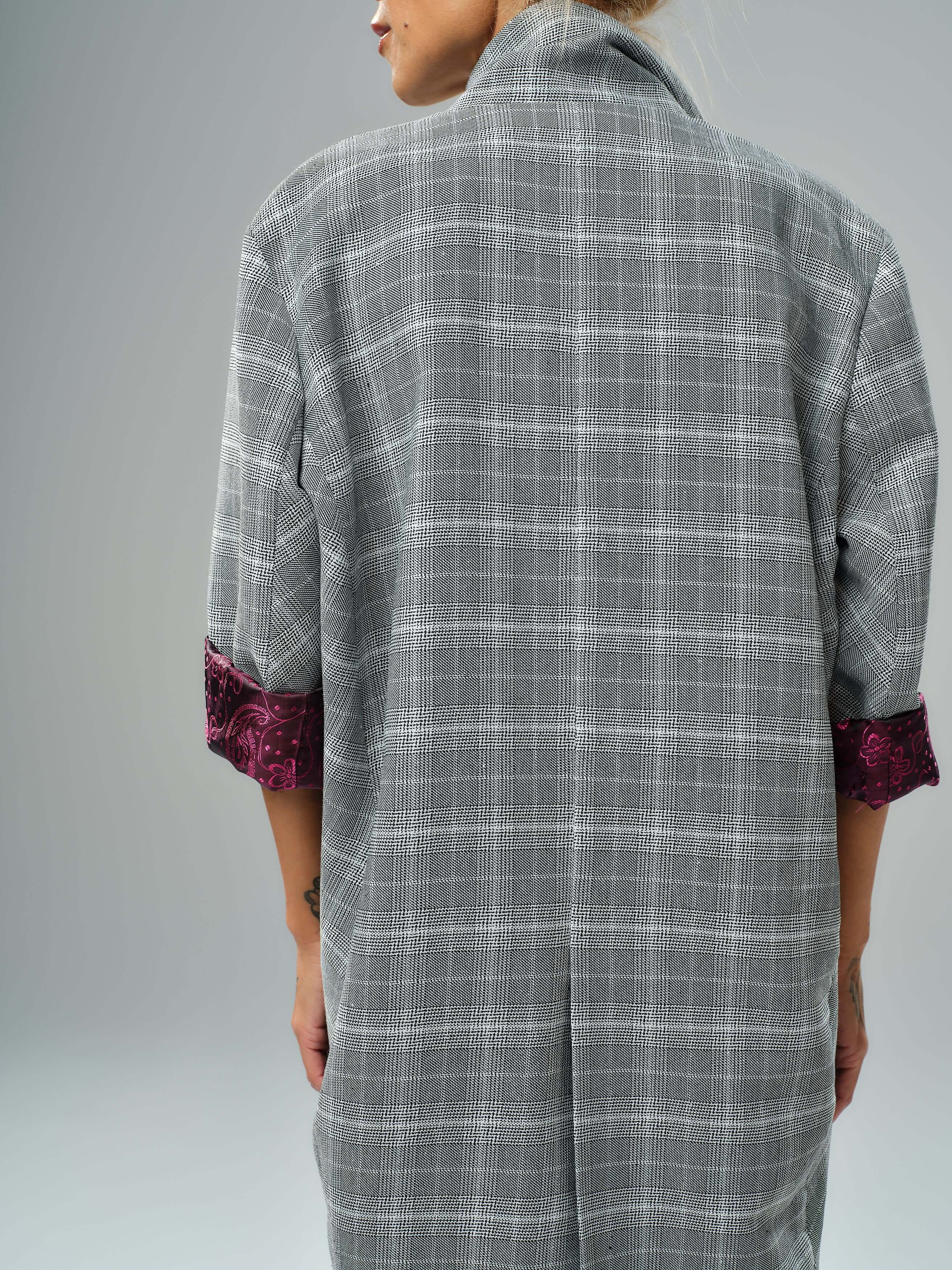 Back view of a light grey checked oversized blazer with burgundy paisley lining on sleeves.