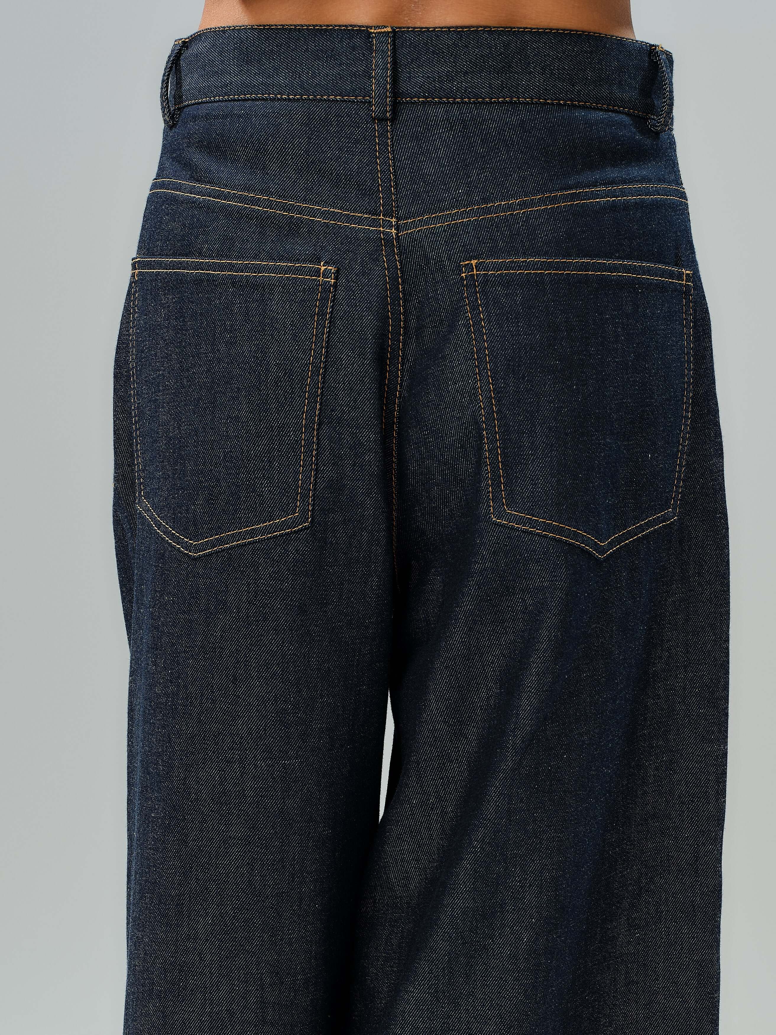 Back view of wide-leg denim jeans featuring contrast stitching and two back pockets.