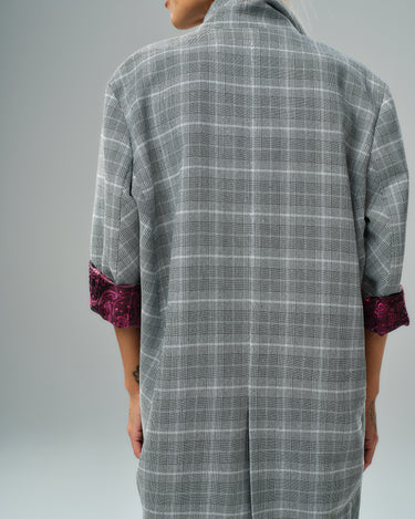 Back view of a light grey checked oversized blazer with burgundy paisley lining on sleeves.