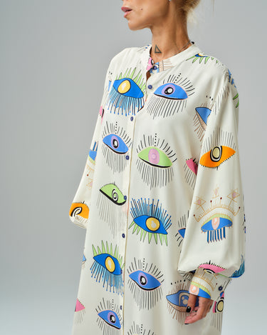 Bold eye print shirt dress with colorful design and ¾ sleeves, perfect for stylish city outings or evenings.