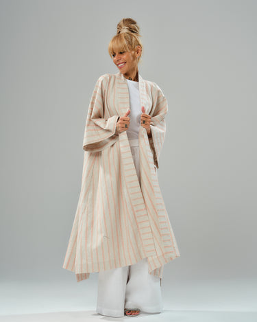 Striped linen-cotton kimono over white outfit, showcasing casual elegance and versatile layering.