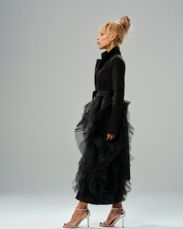 Black Tulle Detail Blazer with satin belt, featuring dramatic tulle accent, modeled with high collar and elegant silhouette.