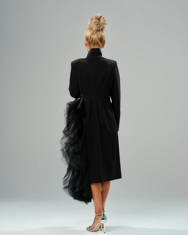 Back view of a black tulle detail blazer with dramatic layered fabric and a high collar design.