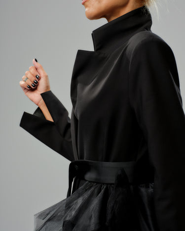 Black tulle detail blazer with satin belt and high collar, showcasing dramatic volume and tailored fit.