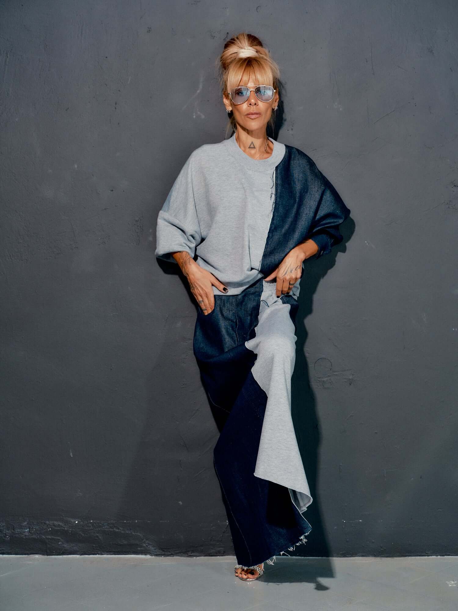 Model wearing a contemporary grey and denim co-ord set, featuring a relaxed sweatshirt and flowing maxi skirt.