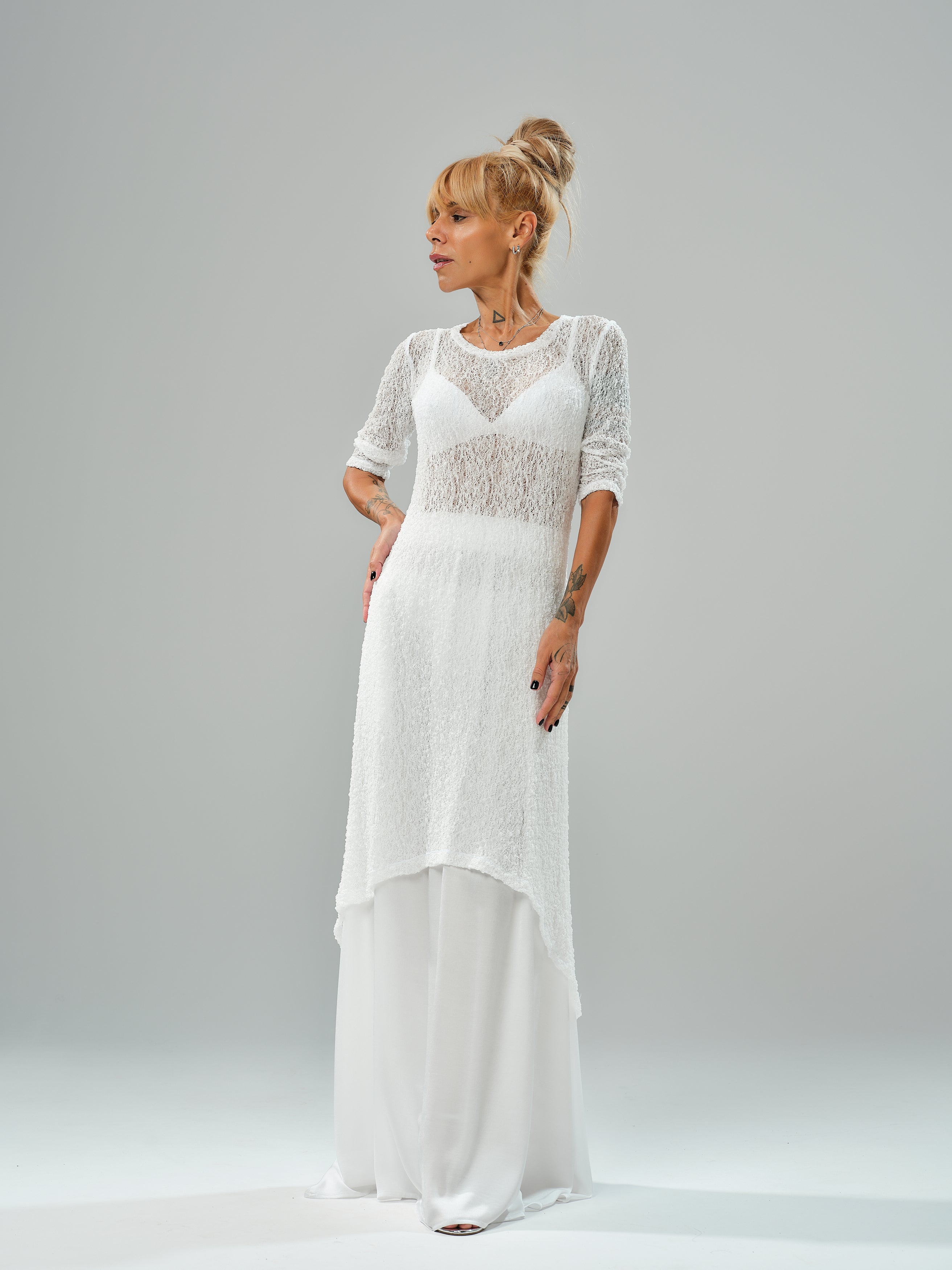 Model showcasing a white maxi co-ord set with tunic and elastic waist skirt, featuring a sheer texture and flowy design.