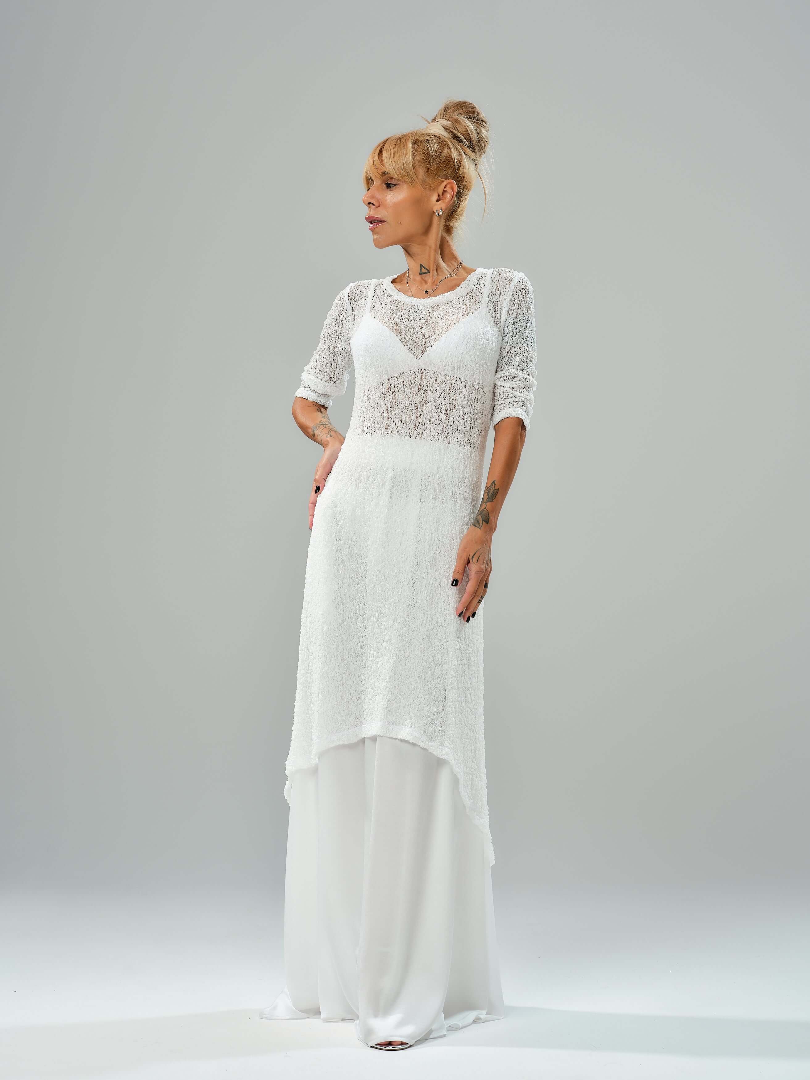 Model showcasing a white maxi co-ord set with tunic and elastic waist skirt, featuring a sheer texture and flowy design.