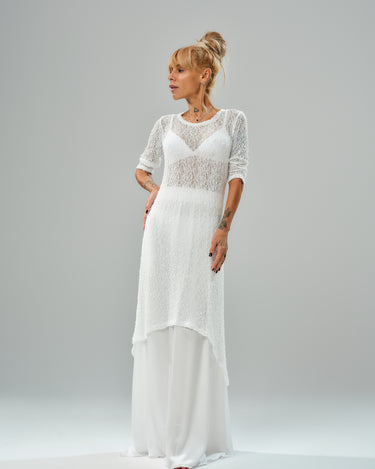 Model showcasing a white maxi co-ord set with tunic and elastic waist skirt, featuring a sheer texture and flowy design.